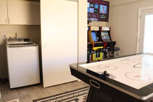 a kitchen with a counter top and a refrigerator at Cowboy Den-Hot Tub-Game Room-Pet Friendly-No Pet Fees! in Albuquerque