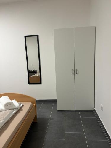 een slaapkamer met een bed en een spiegel bij Pension Imhof in Oyten