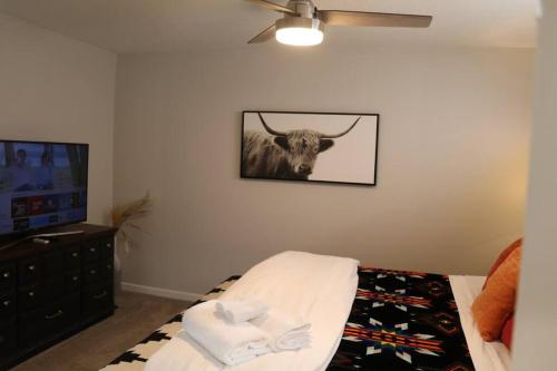 a room with a picture of a bull on the wall at Cowboy Den-Hot Tub-Game Room-Pet Friendly-No Pet Fees! in Albuquerque