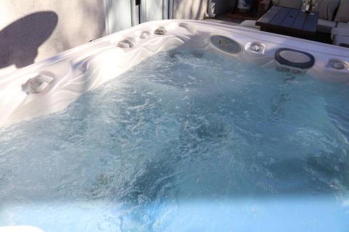 a jacuzzi tub with water in it at Cowboy Den-Hot Tub-Game Room-Pet Friendly-No Pet Fees! in Albuquerque