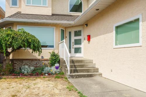 a house with stairs leading up to the door at Steveston Village Bed and Breakfast in Richmond