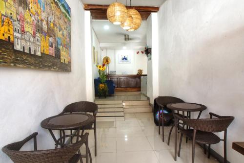 a room with chairs and tables and a hallway at Terraza Catedral Hostel in León