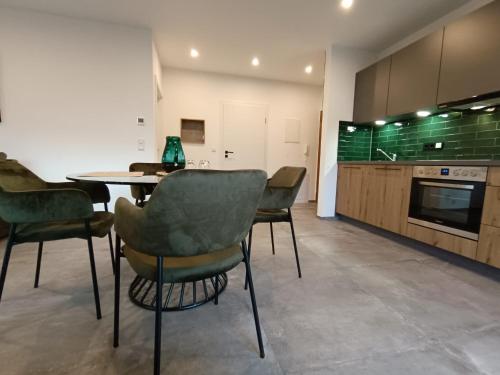 a kitchen with a table and chairs in a room at Ferienwohnung Ott in Bad Endorf