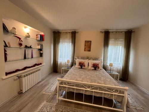a bedroom with a bed in a room at Vila Laurus in Palanga