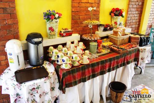 a table with cups and other food on it at The Castello Resort in Ko Larn