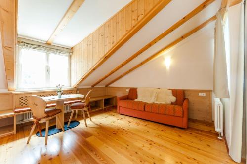 a living room with a couch and a table at Berggasthof Locanda Alpina Dorfner in Montagna