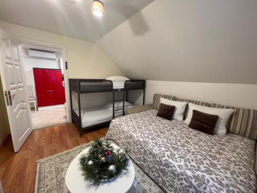 a bedroom with a bed with a christmas tree on it at Vila Laurus in Palanga