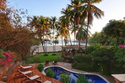 a resort with a swimming pool and a beach at Las Flores Resort in Chirilagua