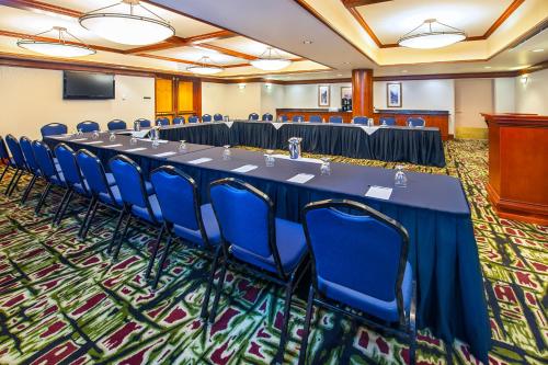 a conference room with a long table and blue chairs at Royal Canadian Lodge in Banff