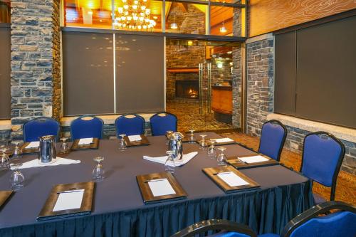 a conference room with a table and blue chairs at Royal Canadian Lodge in Banff