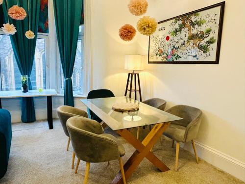 a dining room with a table and chairs at Glasgow Center/West End Apartment in Glasgow