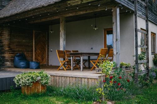 a porch of a house with a table and chairs at Pūjalgi in Ēdole