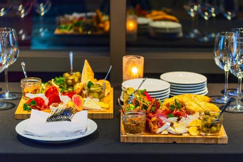 a table with plates of food and glasses of wine at Royal Canadian Lodge in Banff