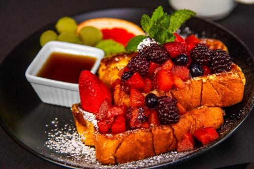 a plate of food with fruit on a table at Royal Canadian Lodge in Banff