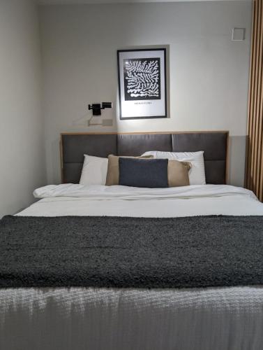 a bedroom with a large bed with white sheets and pillows at BratSki Apartman - 200m od gondole in Brzeće