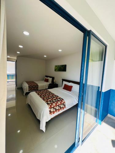 Ένα ή περισσότερα κρεβάτια σε δωμάτιο στο Finca Hotel San Jose