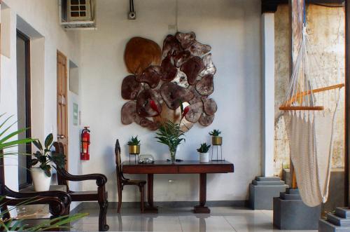 a table in a room with a pile of wood on the wall at Terraza Catedral Hostel in León