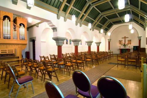 an empty church with chairs and a organ at Haus Hainstein in Eisenach