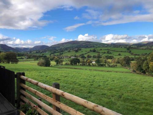 a fence with a view of a green field at The Retreat in Llanrhaeadr-ym-Mochnant