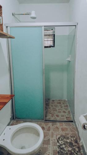 a bathroom with a toilet and a glass shower at Bonito departamento y centrico in Lázaro Cárdenas