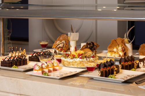 a buffet with many different types of desserts on display at Pickalbatros Laguna Club Resort Sharm El Sheikh in Sharm El Sheikh
