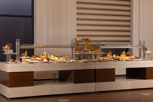 a buffet line with many different types of food at Pickalbatros Laguna Club Resort Sharm El Sheikh in Sharm El Sheikh