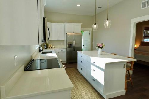 a kitchen with a white counter and a refrigerator at Carmen’s Casita in Tampa
