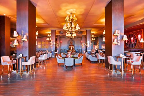 a restaurant with tables and chairs and a chandelier at Pickalbatros Laguna Club Resort Sharm El Sheikh in Sharm El Sheikh