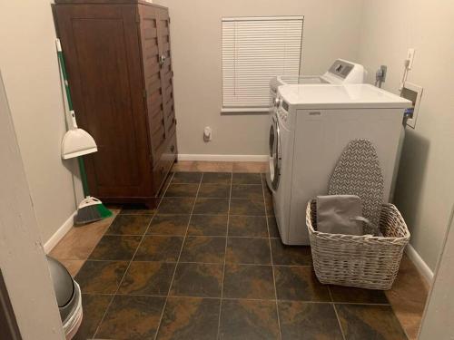 a laundry room with a washing machine and a basket at *3 blocks from AT&T Stadium* 2 bedroom-sleeps 6 in Arlington