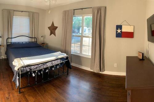 a bedroom with a bed and a large window at *3 blocks from AT&T Stadium* 2 bedroom-sleeps 6 in Arlington