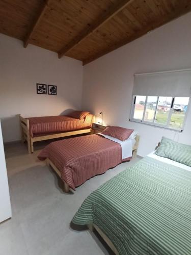 a bedroom with two beds and a window at Casa vacacional LUNA DE MAR in Santa Clara del Mar