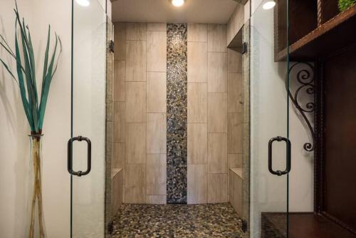 a shower with a glass door in a bathroom at Luxury Downtown Rental (Hot Tub/Pet Friendly) - La Dolce Vita Villas #10 in Moab