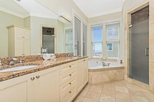 a bathroom with two sinks and a tub and a shower at Kevin's Heaven in Grayton Beach