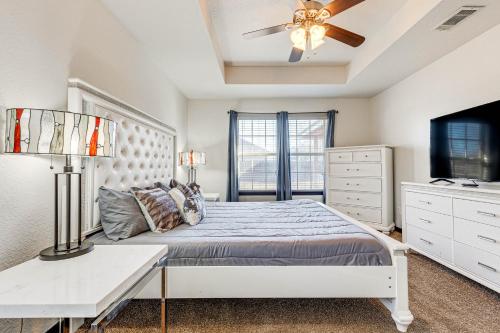 a bedroom with a bed and a ceiling fan at Family-Friendly Ocean Springs Home Grill, Hot Tub in Ocean Springs