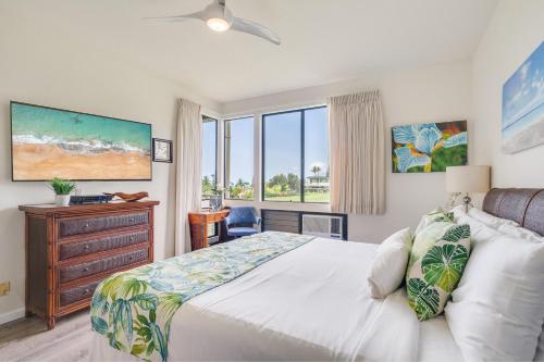 a bedroom with a bed and a dresser and a window at Grand Champions 163 in Wailea