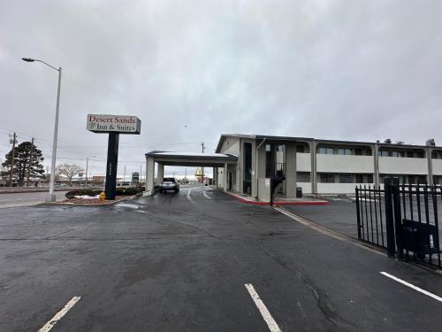 an empty parking lot in front of a gas station at Desert Sands Inn & Suites in Albuquerque