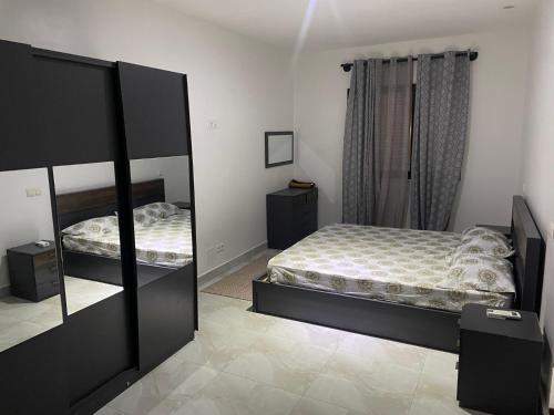 a bedroom with a bed and a large mirror at Magnifique Appart OCEAN BLEU in Dakar