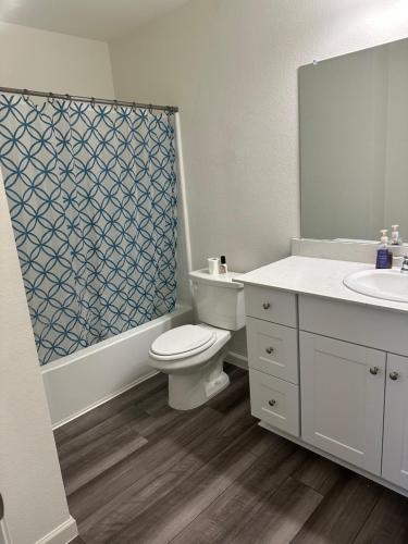 a bathroom with a toilet and a sink and a shower at Cozy modern retreat 20 minutes from Downtown dallas Spacious fresh in Glenn Heights