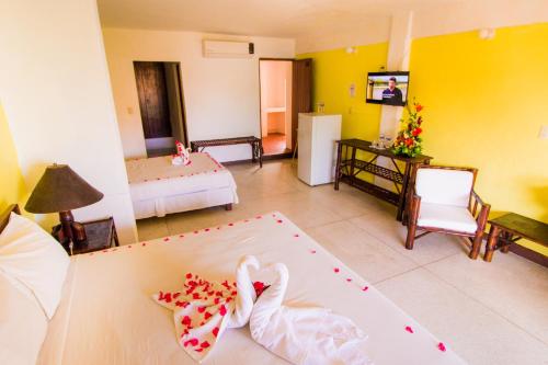 Ένα ή περισσότερα κρεβάτια σε δωμάτιο στο Hotel Zihua Caracol