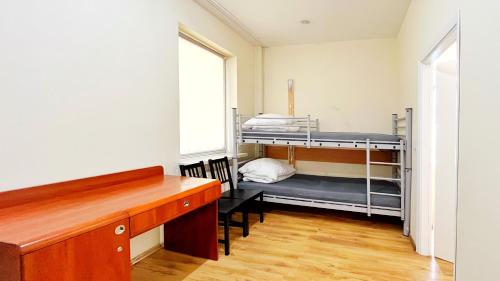 a room with two bunk beds and a desk at Fry House in Warsaw