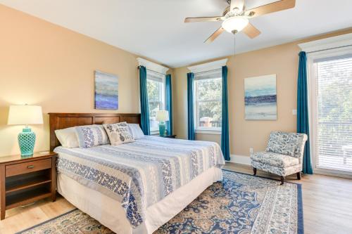 a bedroom with a bed and a chair and windows at Bright and Modern Townhome Steps to Miramar Beach! in Destin