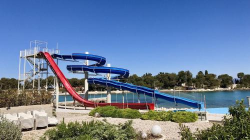a water slide at a water park with chairs at Apartment Karla 4 in Supetar