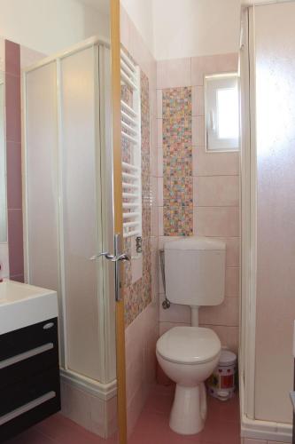 a bathroom with a toilet and a sink at Apartment Karla 4 in Supetar