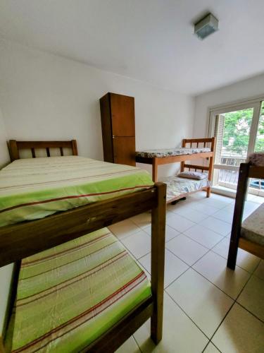 a bedroom with two bunk beds and a window at Man's Place Hostel Masculino in Porto Alegre