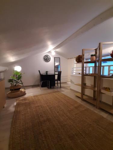 a living room with a table and a dining room at Un nid sur les toits avec terrasse in Apt