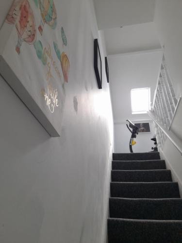 a stairway with a white wall and a stair case at ACCANE in Sunderland