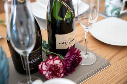 a bottle of wine and two glasses on a table at The Ferns-Ideal base for exploring the Causeway Coast in Armoy
