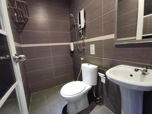 a bathroom with a toilet and a sink at Mozu Hotel Sri Hartamas in Kuala Lumpur