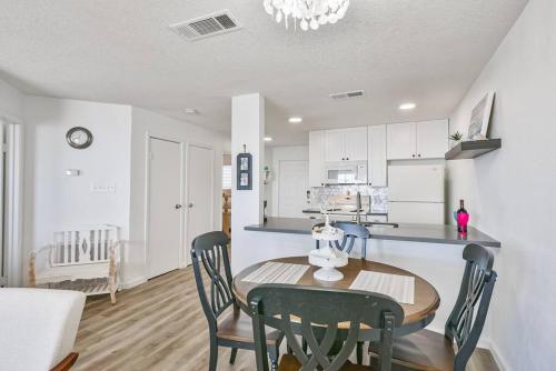 a kitchen and dining room with a table and chairs at Baca Beach Escape II in Galveston