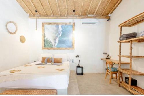 a bedroom with a bed and a wooden ceiling at Alma Surf Villas 01 - Cozy 01 Bed with Private Pool in Uluwatu